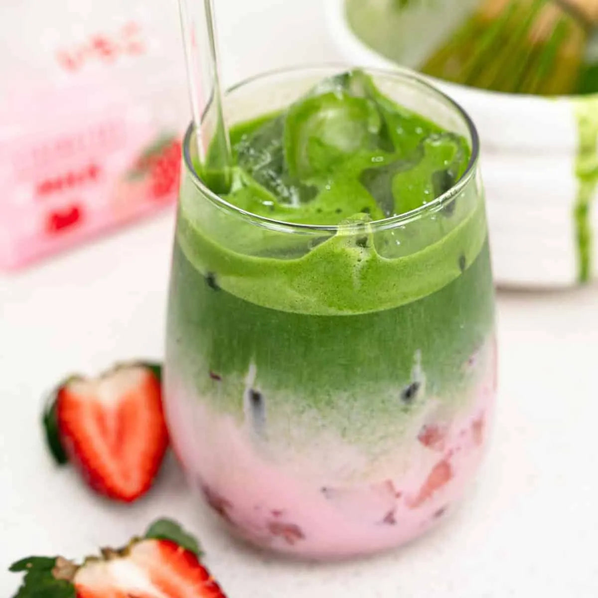 Layered strawberry matcha latte iced drink in clear glass Dubai summer café style